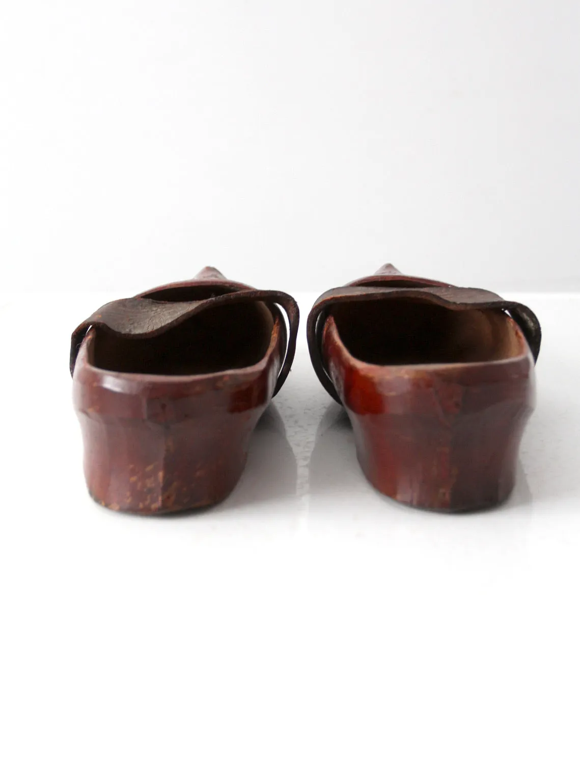 antique carved wood clogs