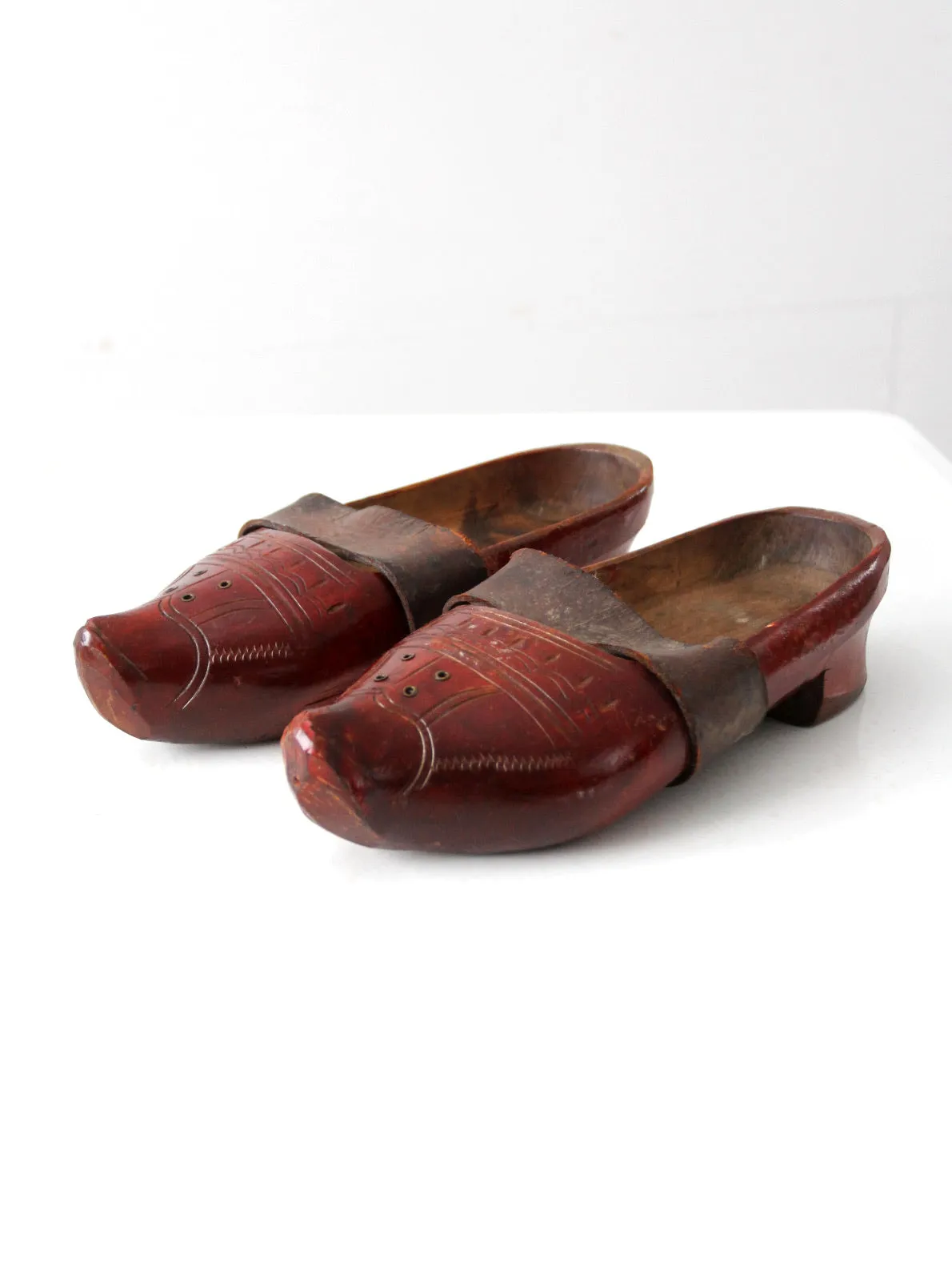 antique carved wood clogs