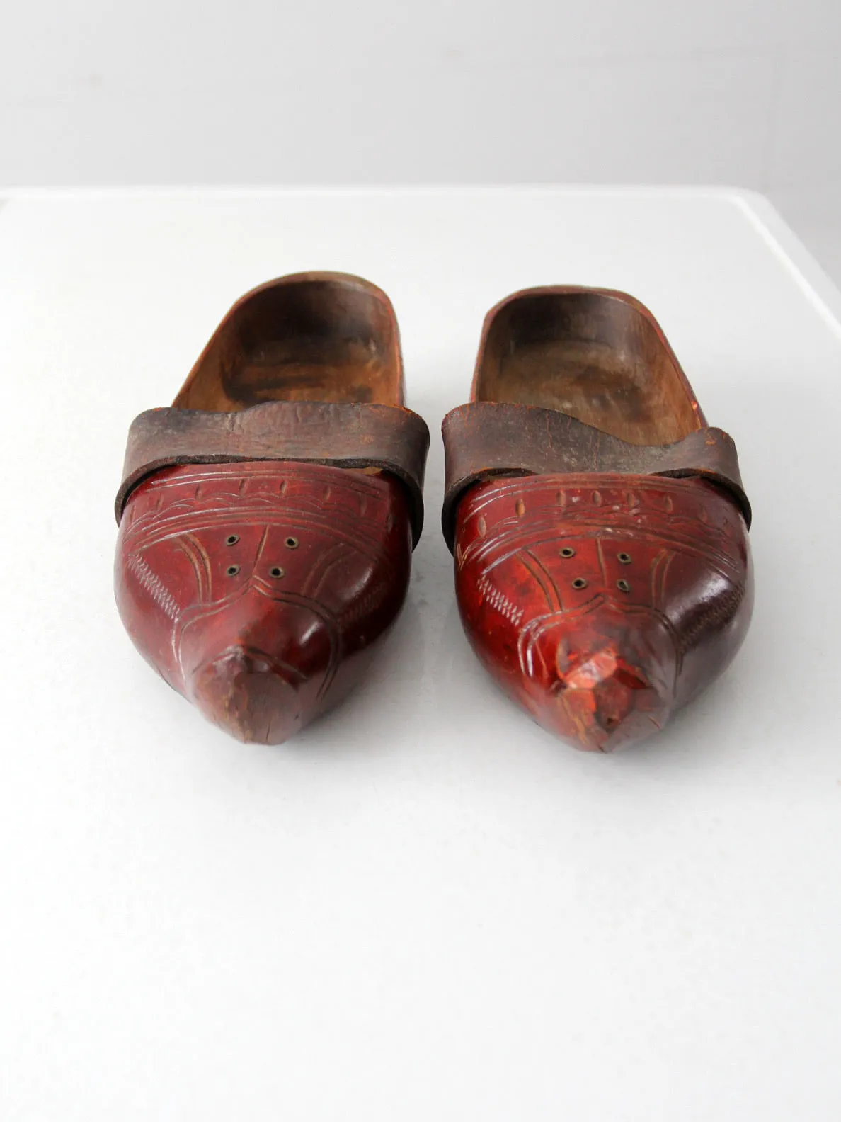 antique carved wood clogs